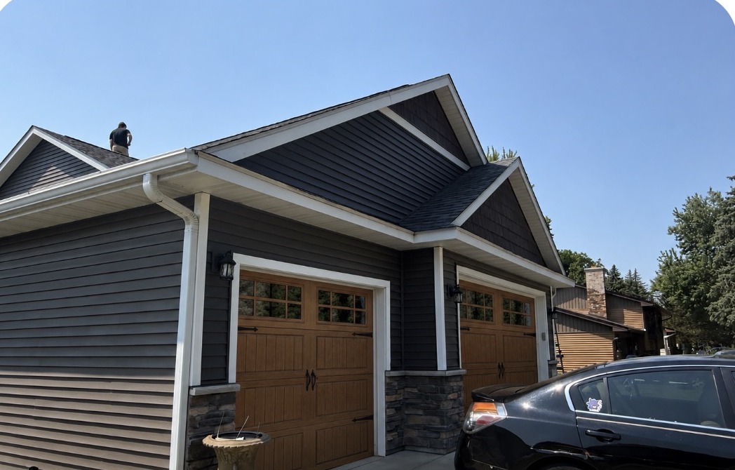 AI concept of the same home with woodgrain carriage-style garage doors and window inserts